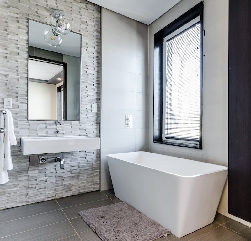 How to Pick the Best Tiles for Your Bathroom: A Complete Guide for 2023 5 white ceramic bathtub near white framed window
