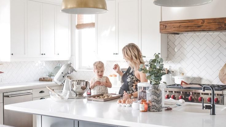 family in kitchen ringing together families of different generations.