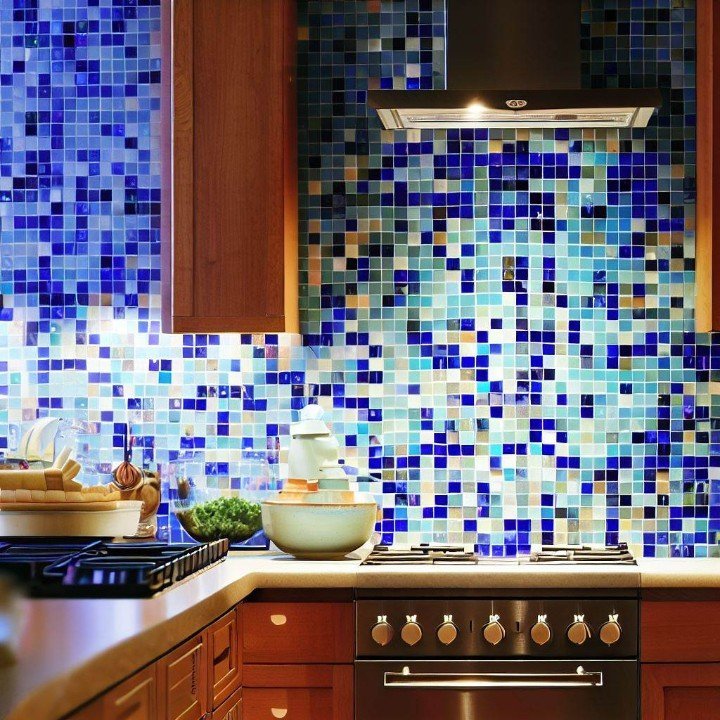 a kitchen with mosaic tiles with blue grout as the backsplash