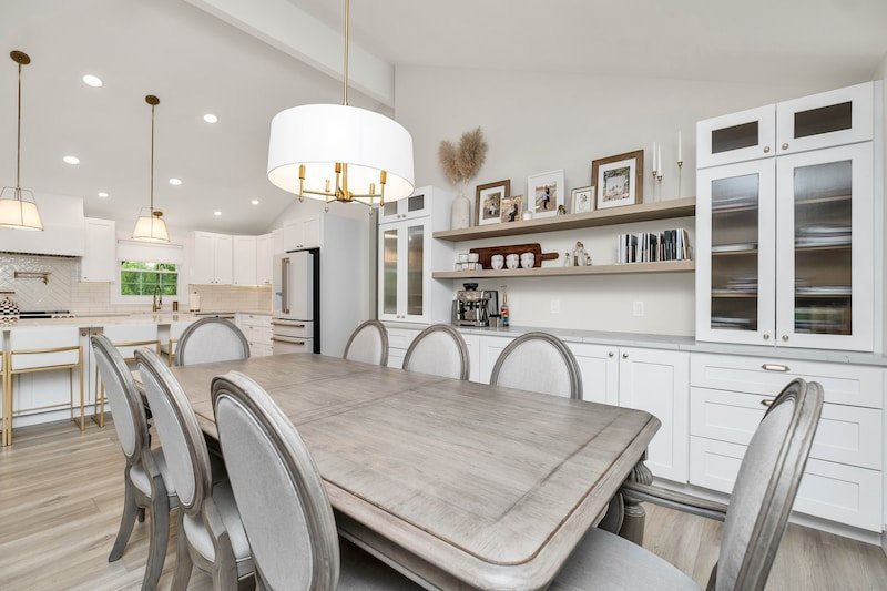 a large kitchen with a table and chairs in it